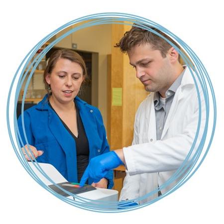 A student works alongside Dr. Balog in her lab