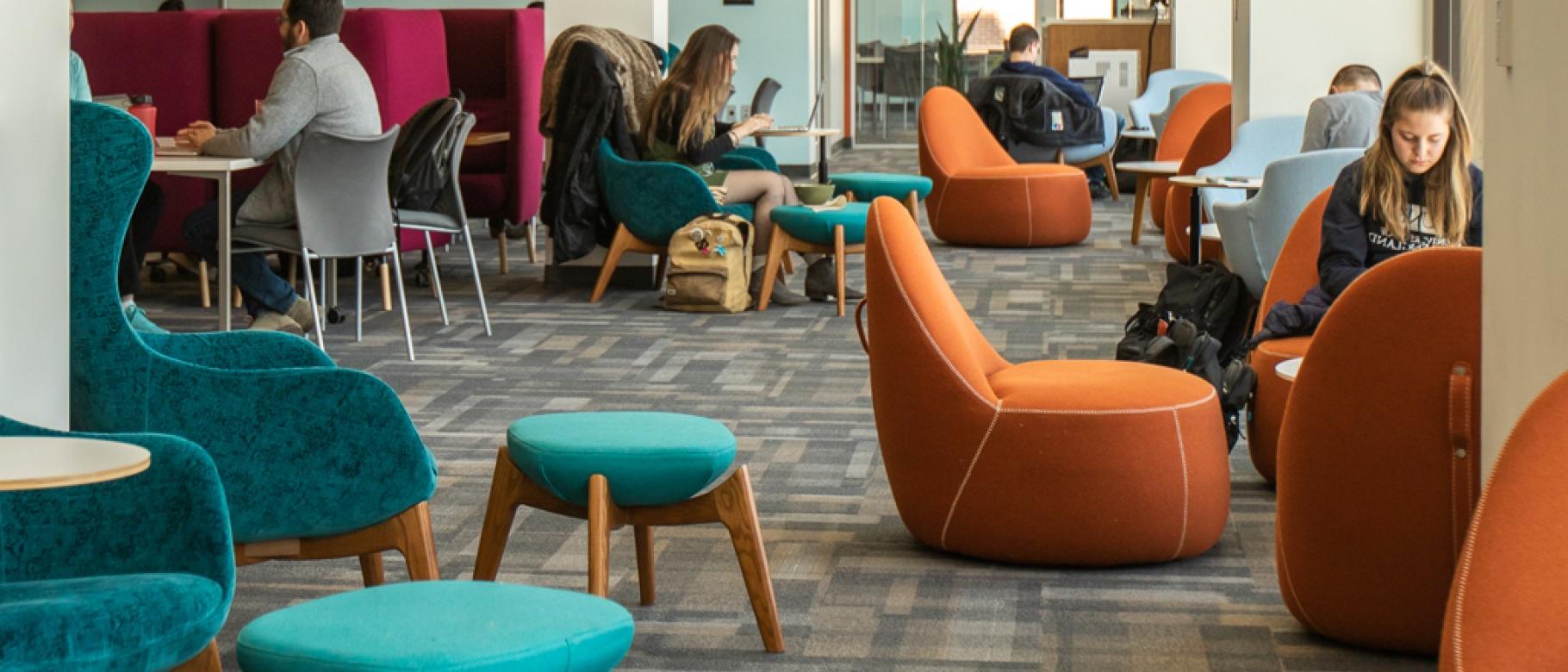 Several students studying in the Commons